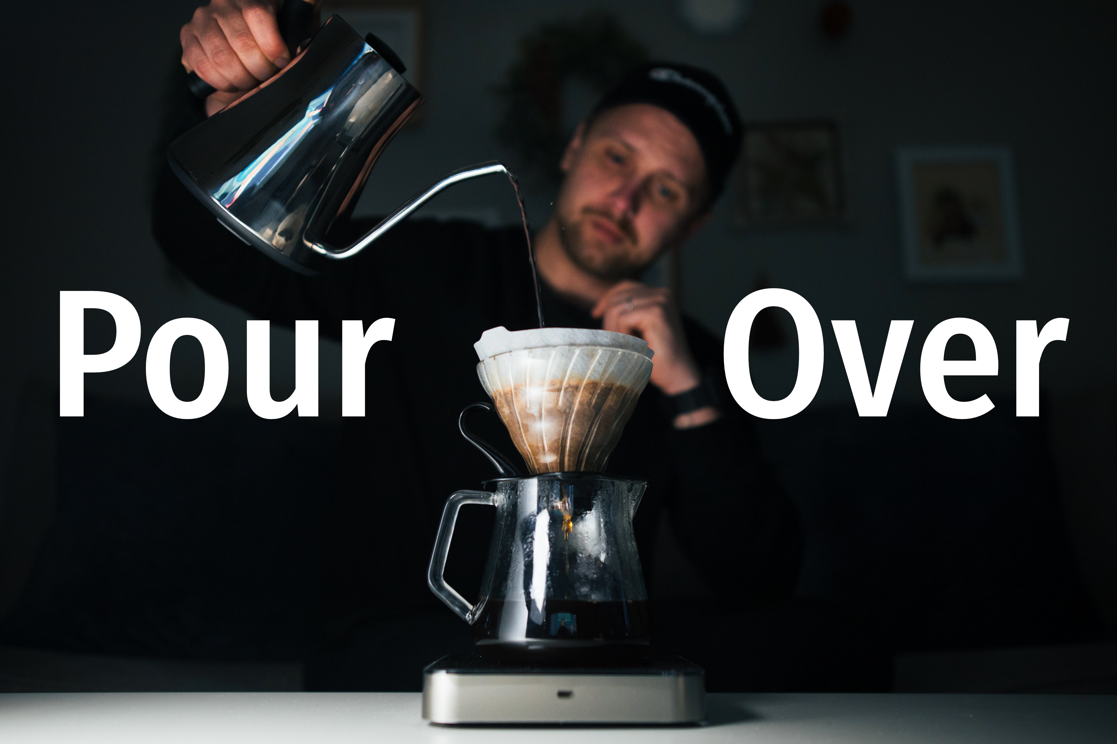 Coffee being brewed with the pour over brewing method using a kettle, V60 brewer, and a scale.