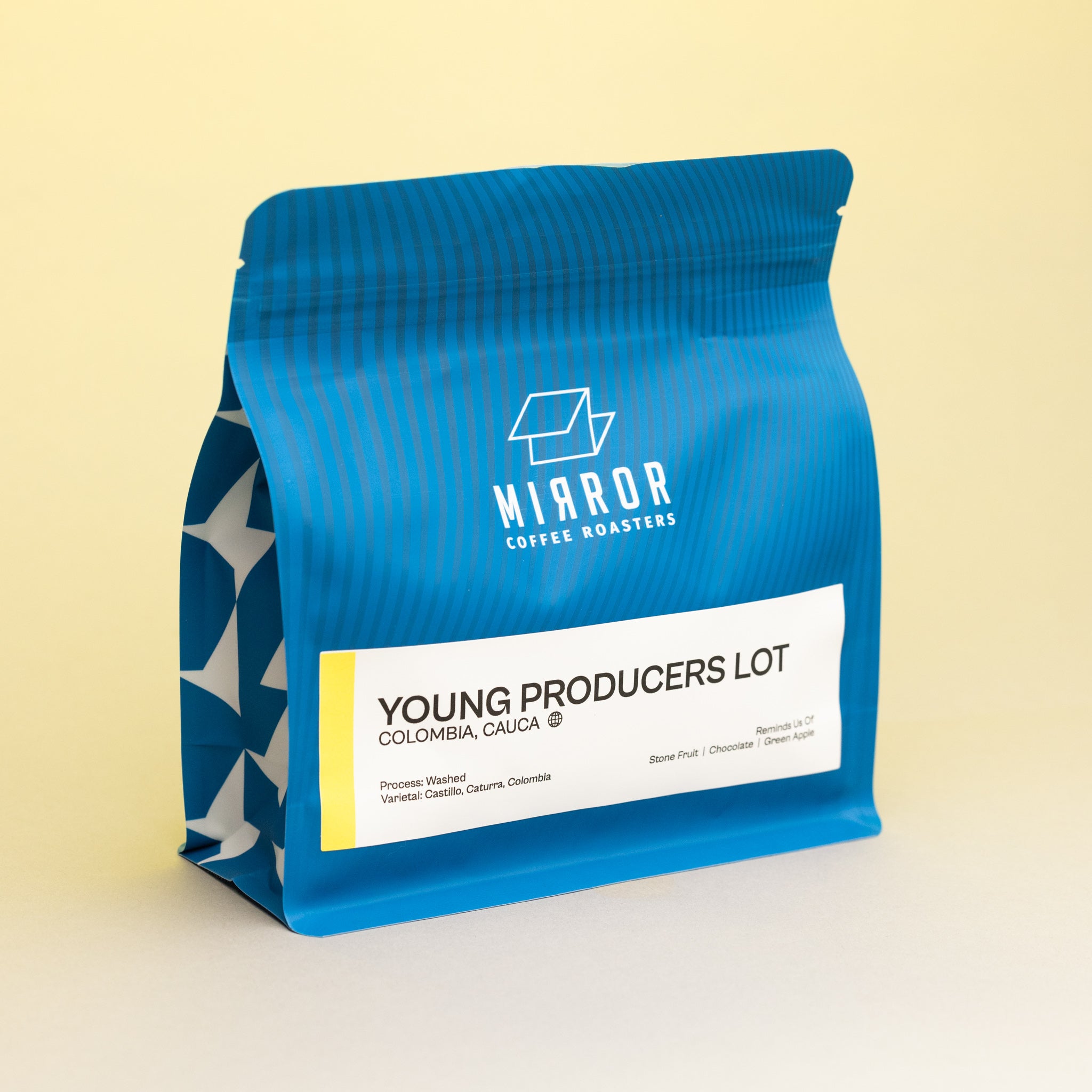 Bag of coffee with the name Young Producers Lot on it from the origin of Colombia. Has Mirror Coffee Roasters branding on it
